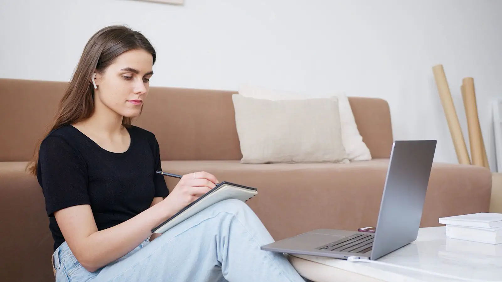 An adult MBA student reviewing material on a laptop in a bright study setting